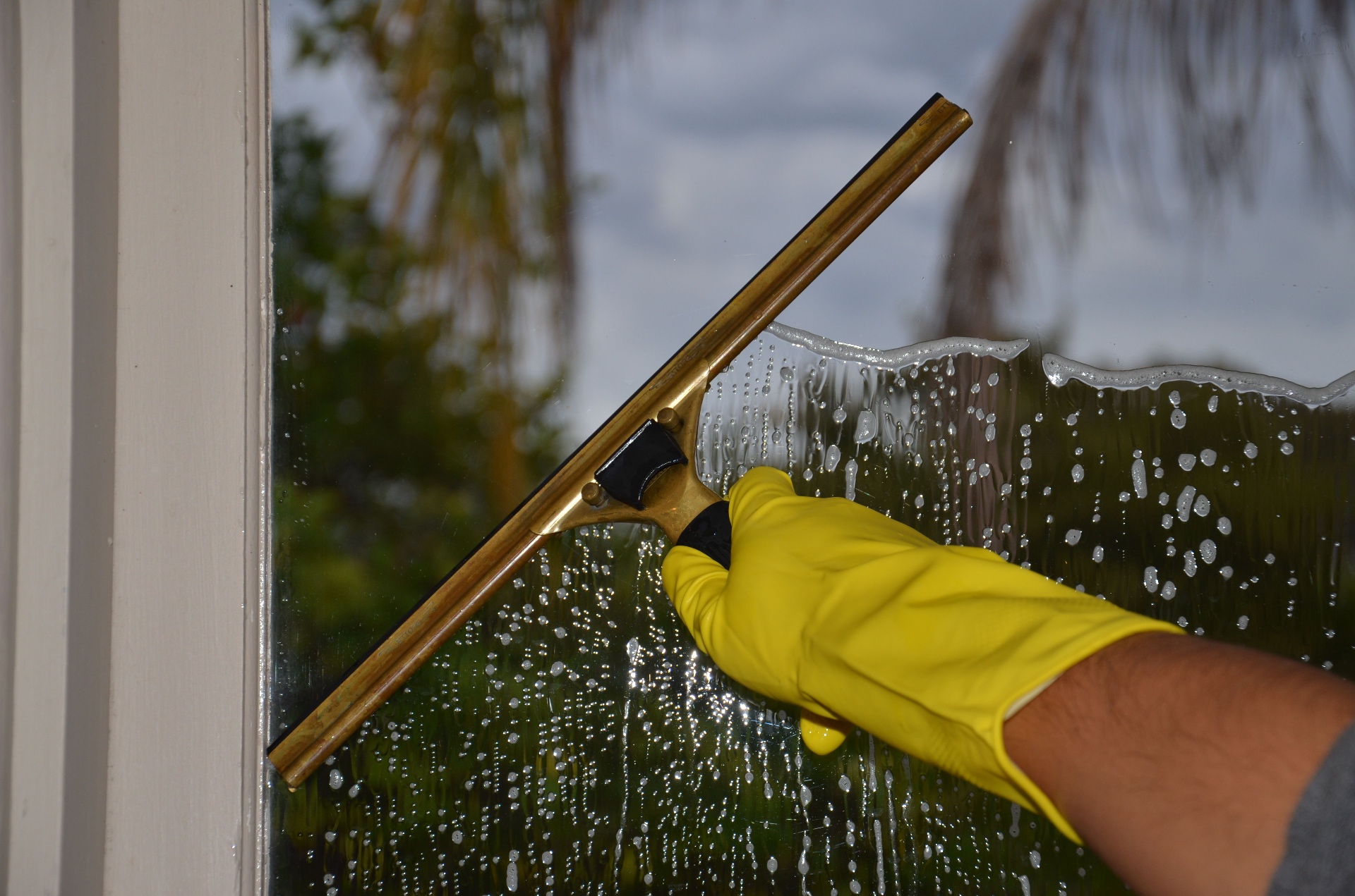 Streak-free window cleaning with a squeegee on a Toronto home